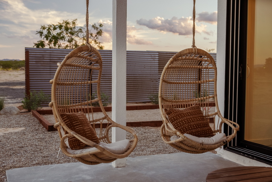 Hnaging boho rattan chairs with a boho vibe to complement desert landscape