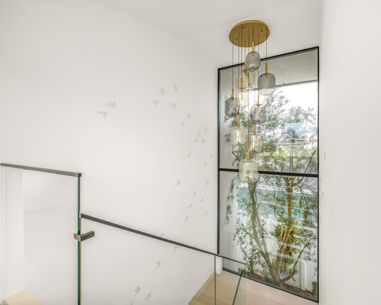 custom built glass rail staircase and large window